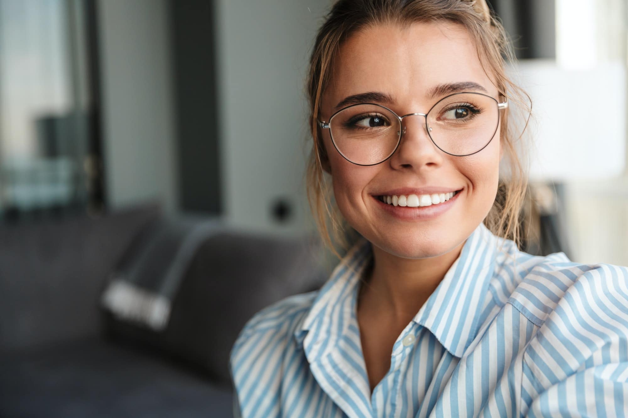 Image closeup of cheerful nice woman smiling and looking aside